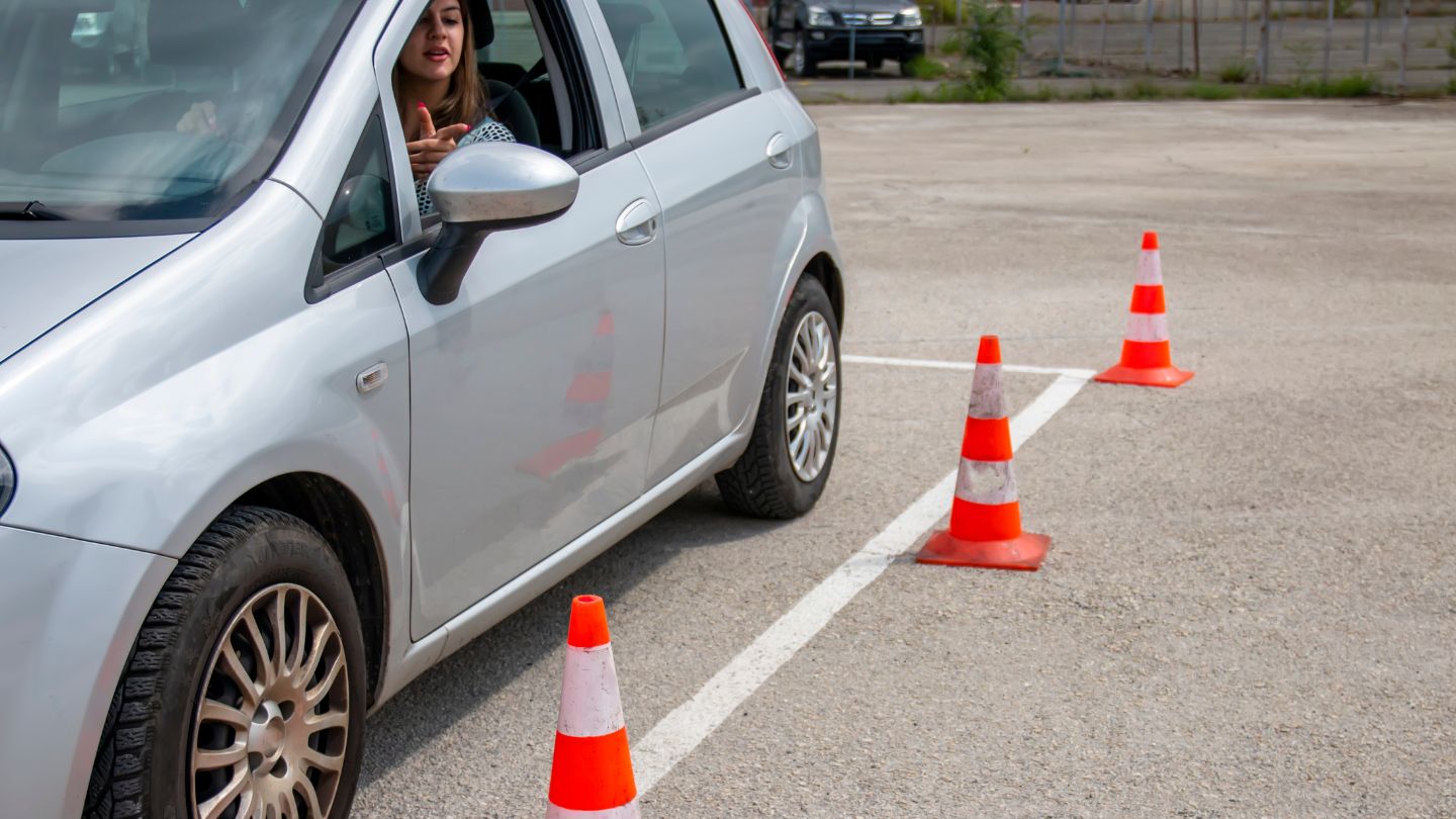 Driver Practicing Parallel Parking With Cones 