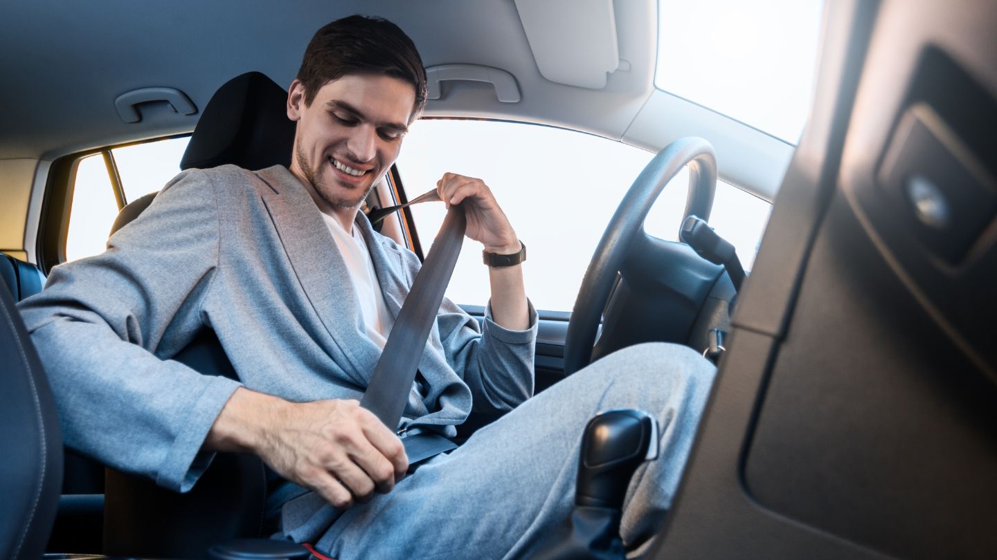 Man Putting on Seatbelt in Car