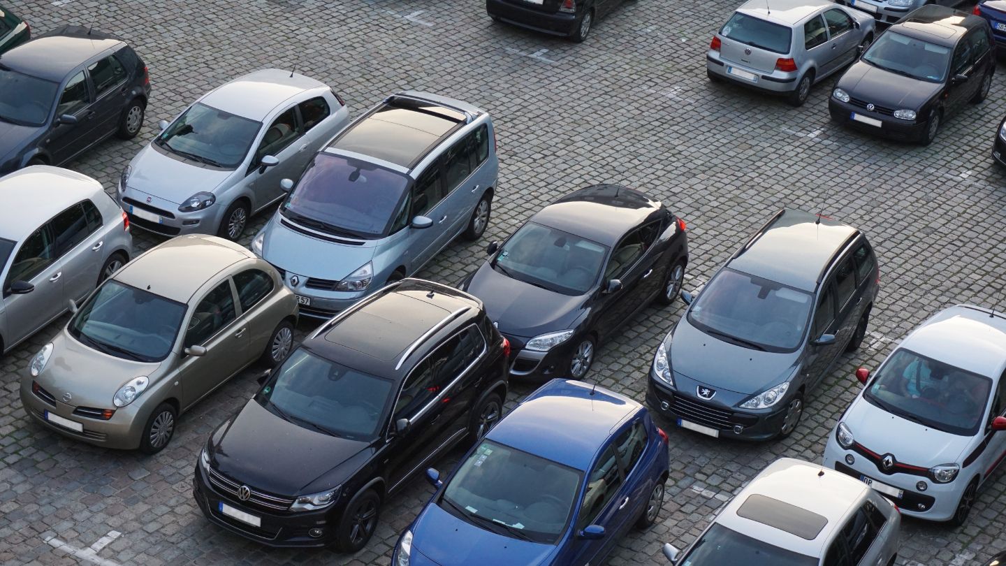 Multiple Parked Cars In A Paved Lot 