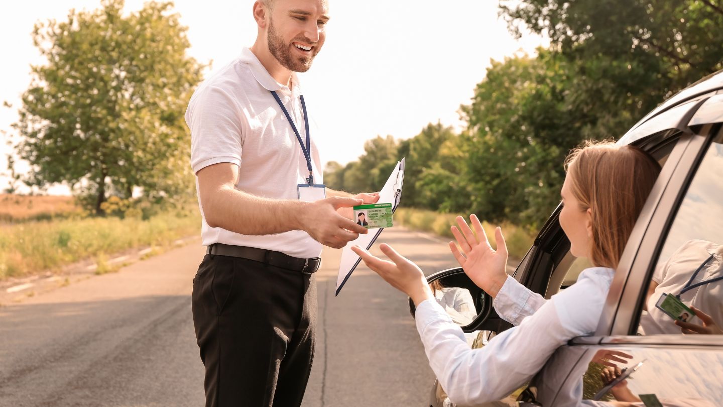 Person Handing Documents to Driver 