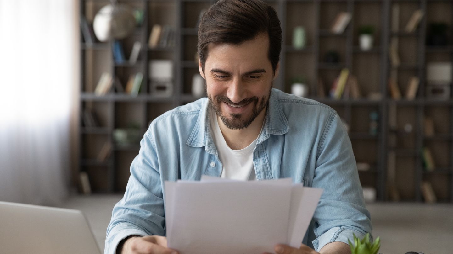 Man Reviewing Documents At Home 