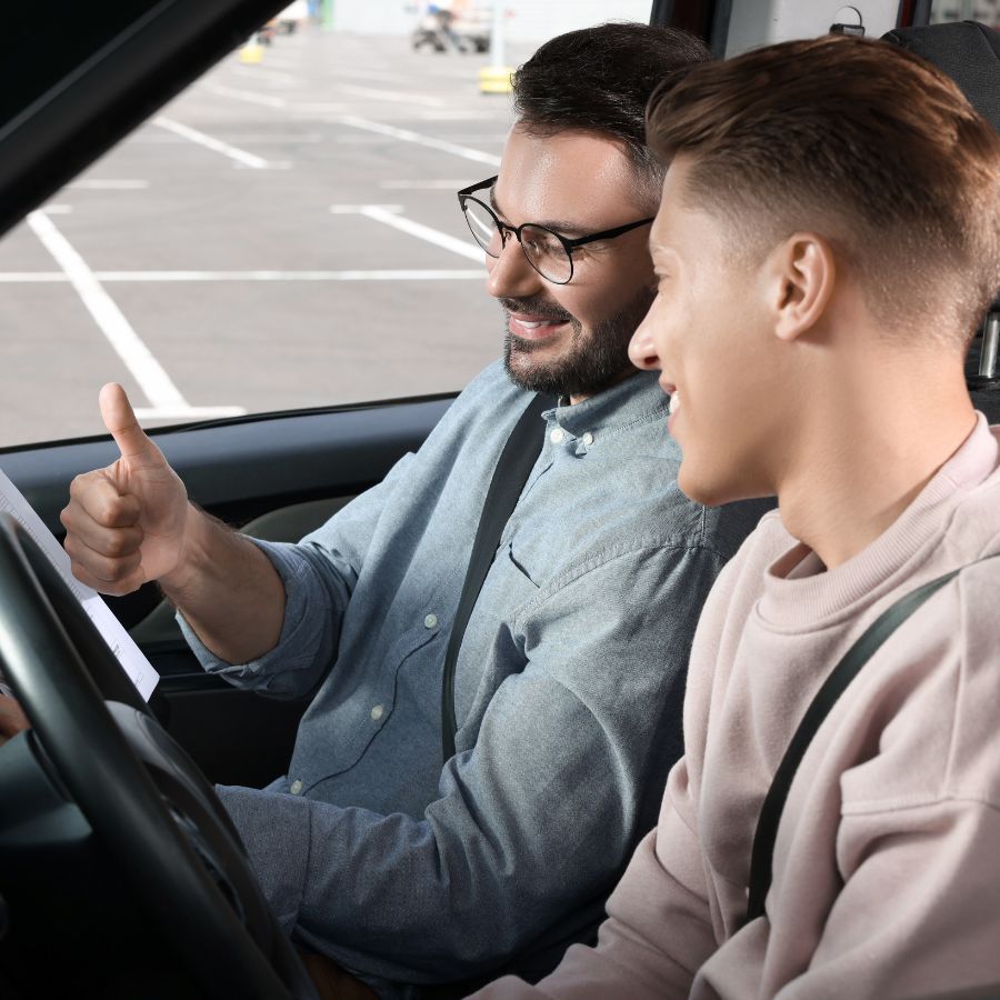 Driving Instructor Guiding A Student