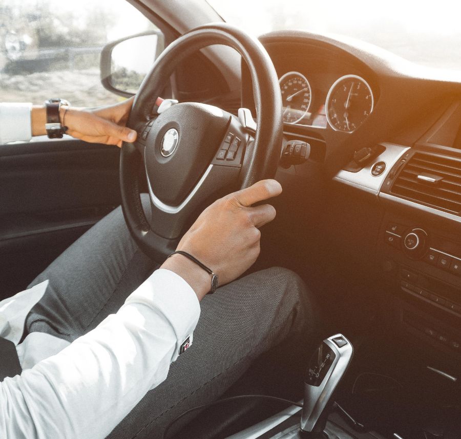 Hands On A Steering Wheel During A Driving Lesson